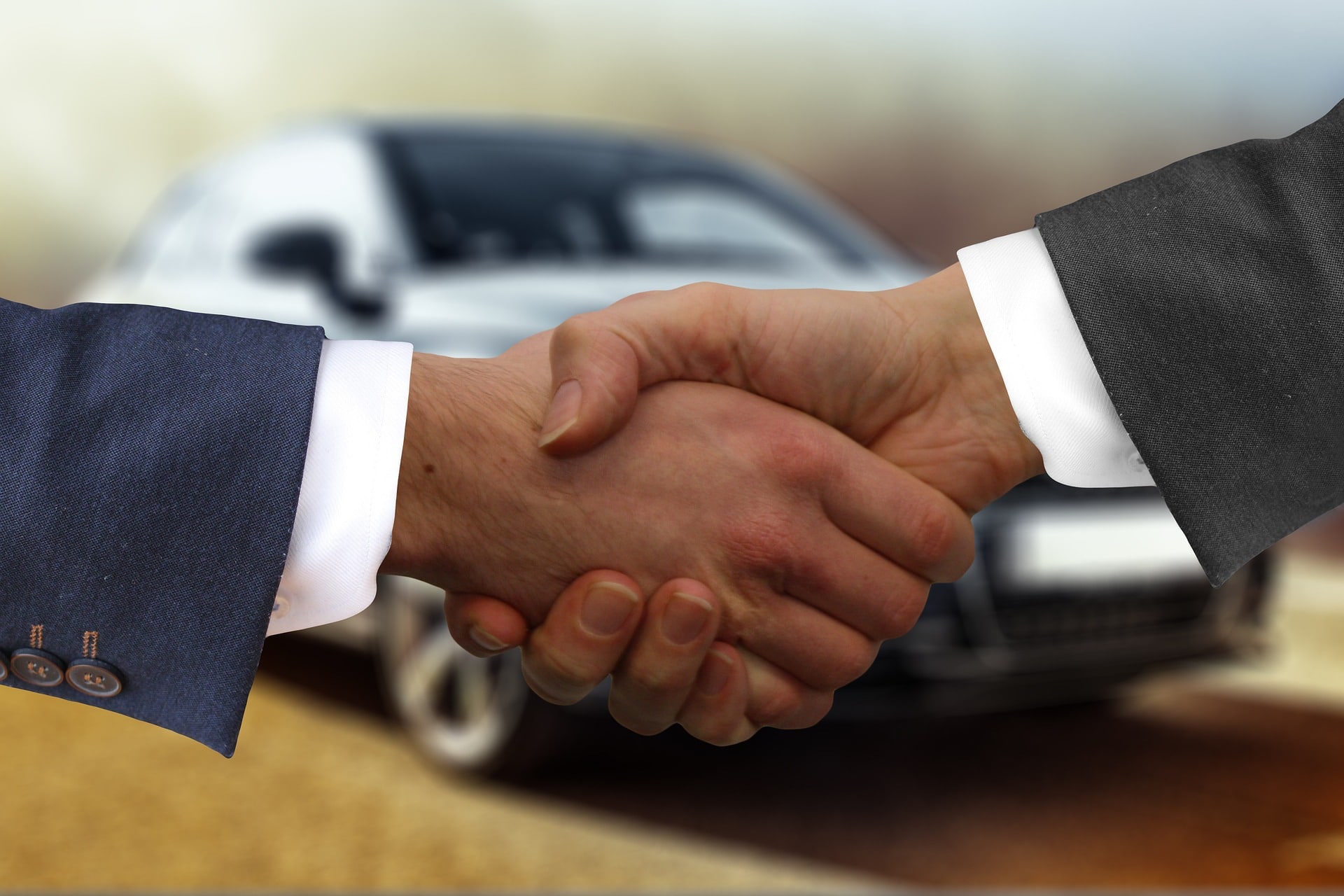 Car dealer shaking hands